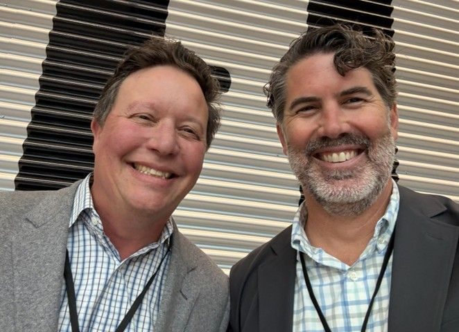 Jon Previtali and Ross Heiman at the NX Solar Insurer Forum, both in blue check shirts and grey jackets